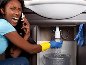 Emergency plumbing repair for a leaking sink drain under a bathroom vanity in Escondido, CA