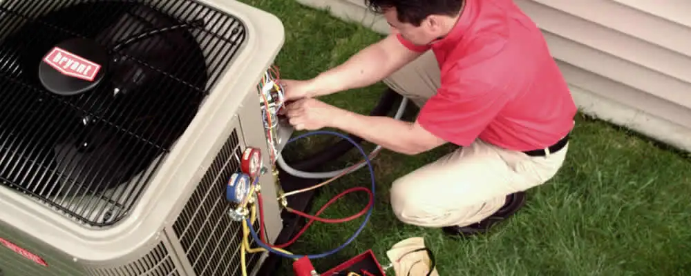 HVAC technician servicing an outdoor air conditioner unit in Escondido, CA